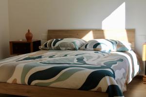 a bed with a blanket and pillows on it at Seaside Apartments - Central Apartments with View - Molfetta in Molfetta +24 photos