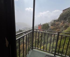 a view from the balcony of a house at mount wood heritage in Dharmsāla