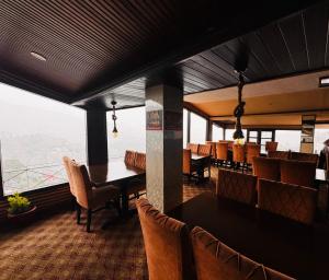 a restaurant with a table and chairs and a view at mount wood heritage in Dharmsāla