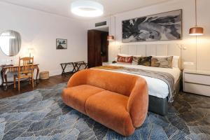 a bedroom with a large bed and a chair at Oude Werf Hotel in Stellenbosch +168 photos