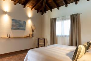 a bedroom with a white bed and a window at Sweet Caroline in Villaverde