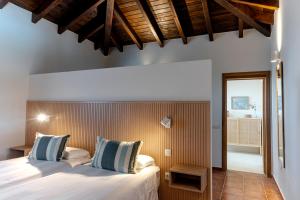 a bedroom with two beds and a wooden wall at Sweet Caroline in Villaverde +32 photos