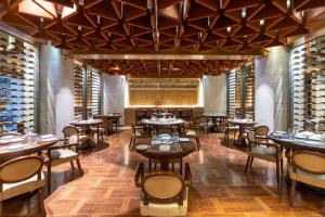 a restaurant with tables and chairs in a room at The Soaltee Kathmandu, Autograph Collection in Kathmandu