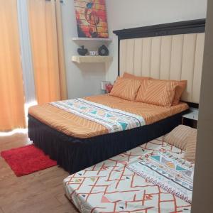 a bed in a room with at Amani Airport Haven - 726 in Pusok +8 photos