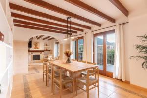 a dining room with a wooden table and chairs at Casa "Valldemossa Paradise" in Valldemossa