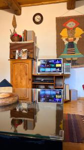 a living room with a table and a clock on the wall at Drevenica pod Tlstou in Blatnica