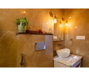 a bathroom with a toilet and a sink and a mirror at Casa De Alegria Goa in Canacona