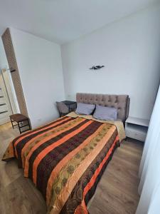 a bedroom with a large bed in a room at Muskatas in Rietavas