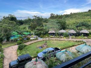a view of a garden with two trucks parked in a yard at Luzviminda Farm Homestay in Coron