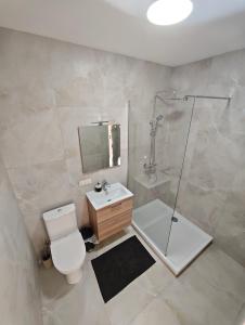 a bathroom with a shower and a toilet and a sink at Muskatas in Rietavas +5 photos