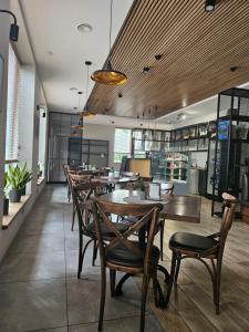 a dining room with wooden tables and chairs at Muskatas in Rietavas