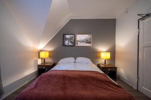 a bedroom with a large bed with two lamps at Old Town Reykjavik in Reykjavík