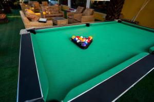 a pool table with a pile of balls on it at Eastern Plus Hotel in Somanya