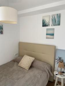 a bedroom with a bed and a table with a lamp at Europa A- 12º-23 in Cullera