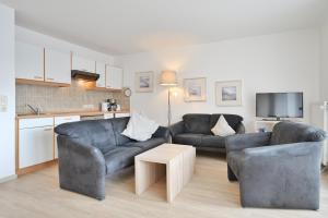a living room with two couches and a table at FeWo Grytz in Dahme