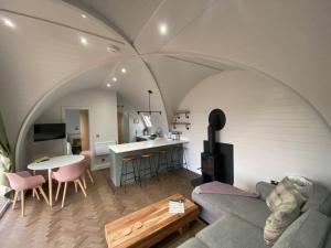 a living room with a couch and a table at Dornoch Pods in Dornoch