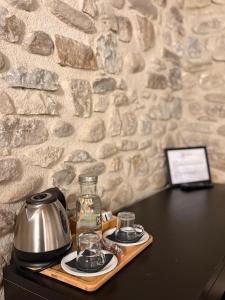 a tray with a tea kettle and glasses on a table at Burruzkale Etxea in Murueta-Orozko +25 photos