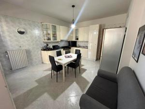 a kitchen and dining room with a table and chairs at Dimora Il Roseto in Trani