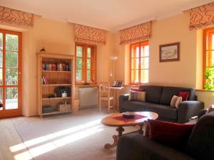 a living room with a couch and a table at Die Landhofmühle in Windisch Minihof