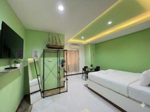 a bedroom with a bed and a television and a table at Similan Mondo Resort & Camping in Phang-nga