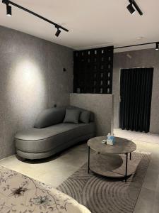 a living room with a couch and a table at استديو المنام الراقي in Medina +2 photos