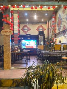 a dining room with tables and a large screen at SUN Homestay sa pa in Sapa