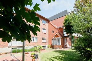 a red brick building with a yard in front of it at Haus Meyer-Teerling - Ferienhaus in Borkum