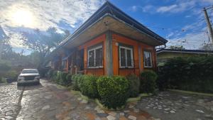 a house with a car parked in front of it at D' TRAVELLERS Inn PUERTO in Puerto Princesa City