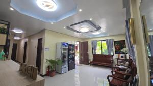 a room with a living room with a couch at D' TRAVELLERS Inn PUERTO in Puerto Princesa City