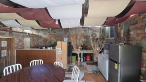 a kitchen with a table and a refrigerator at D' TRAVELLERS Inn PUERTO in Puerto Princesa City
