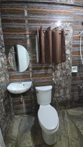 a bathroom with a toilet and a sink at D' TRAVELLERS Inn PUERTO in Puerto Princesa City +40 photos