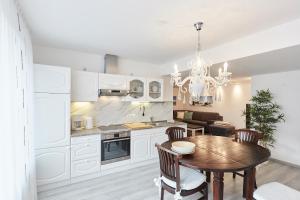 a kitchen with a table and a dining room at Ferienhaus Lina in Borkum
