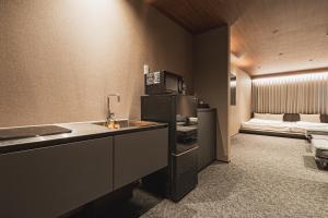 a hotel room with a kitchen and a bed at The LOFT INN NAGASAKI in Nagasaki