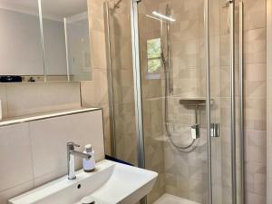 a bathroom with a shower and a sink at Achtern Diek 12b - Wohnung 5 in Müggenburg +24 photos