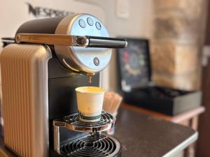a coffee maker is pouring coffee into a cup at Burruzkale Etxea in Murueta-Orozko