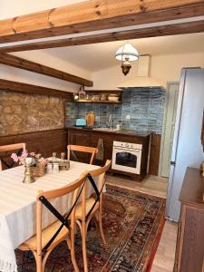 a kitchen with a table and chairs in a room at Happy House Progled in Progled