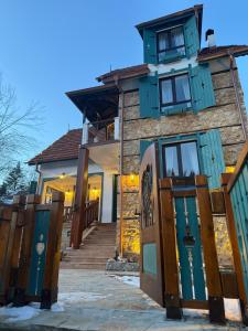 a house with blue doors and stairs in front at Happy House Progled in Progled