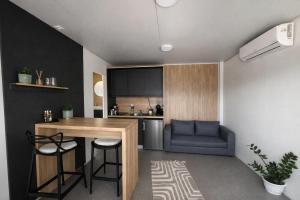a kitchen with a table and a blue couch at Sea Mobile Home in Sukošan