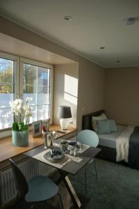 a room with a bed and a table and chairs at Wohnung Burghaus 1 EG in Krummhörn