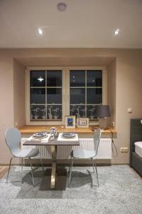 a dining room with a table and two chairs at Wohnung Burghaus 1 EG in Krummhörn