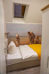 a bedroom with a painting of children on a bed at Wohnung Burghaus 5 OG in Krummhörn