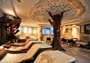 a room with a tree on the ceiling at Appartement Chesa Monte in Ischgl