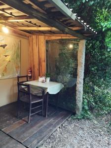 a table and chairs sitting on a wooden deck at Natura Tiny House Porto in Valongo +12 photos