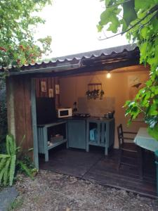 an outdoor kitchen with a table and a microwave at Natura Tiny House Porto in Valongo