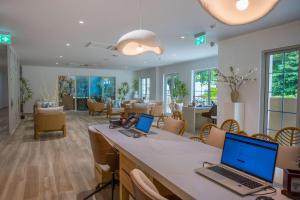 a waiting room with two laptops on a counter at Acajou Beach Resort in Baie Sainte Anne +156 photos
