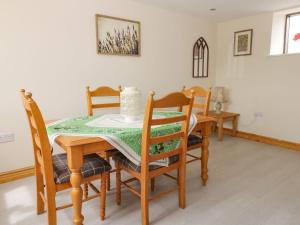 a dining room table and chairs with a cake on it at Lavender Lodge in Hull