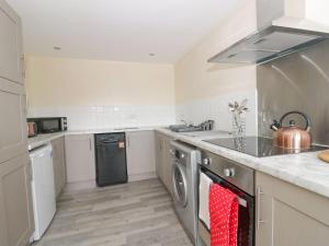 a kitchen with a stove and a tea kettle at Lavender Lodge in Hull
