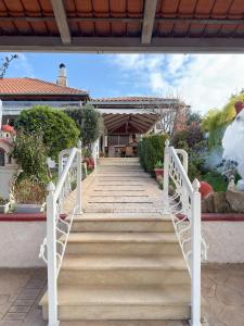 a set of stairs leading to a house at Stone Haven & Garden near the Sea in Methoni