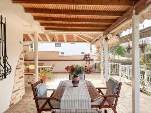 a patio with a table and chairs on a patio at Stone Haven & Garden near the Sea in Methoni