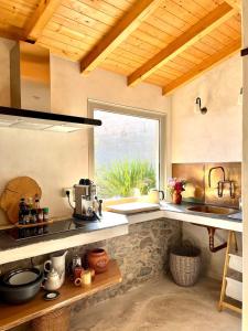 eine Küche mit Spüle und Fenster in der Unterkunft Casa 5A - Refúgio Intimo e privado com design e pátio acolhedor in Oliveira do Mondego